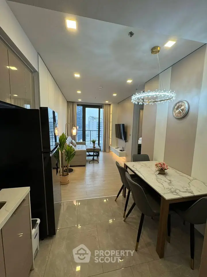 Modern open-layout living and dining area with elegant decor and city view.
