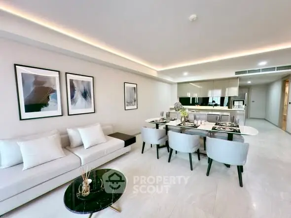 Modern open-plan living room with elegant dining area and sleek kitchen design.