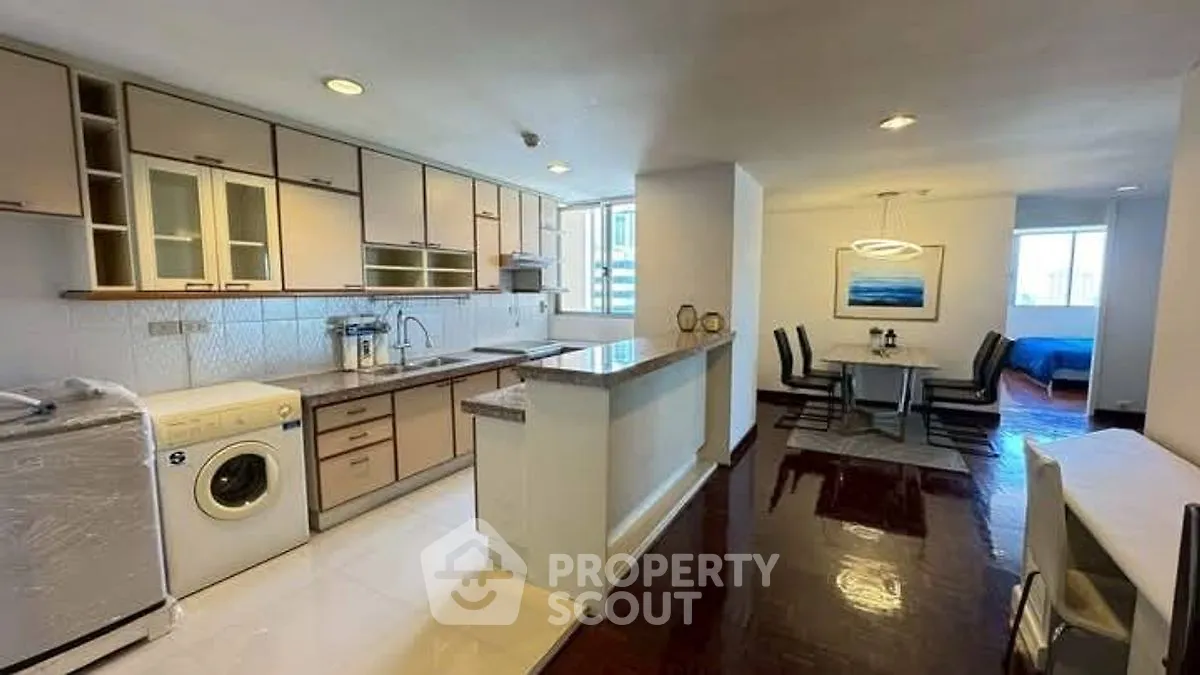 Spacious open-layout kitchen with modern appliances and dining area, perfect for entertaining.