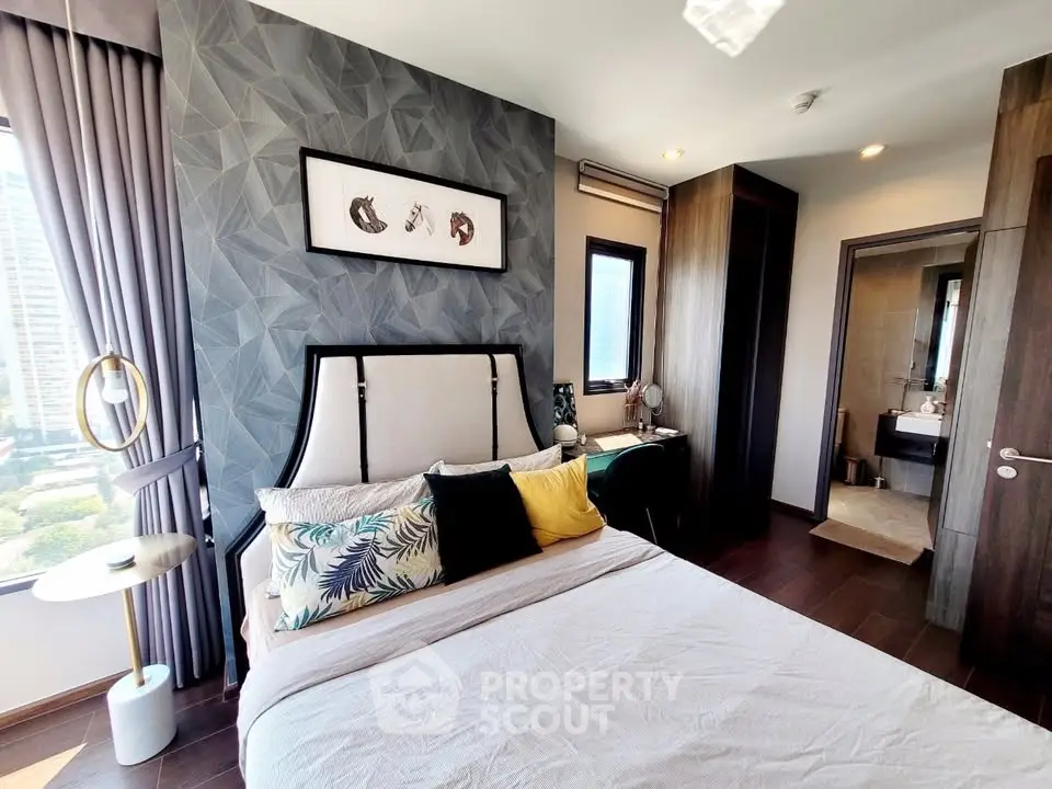 Modern bedroom with stylish decor and city view, featuring elegant furnishings and natural light.