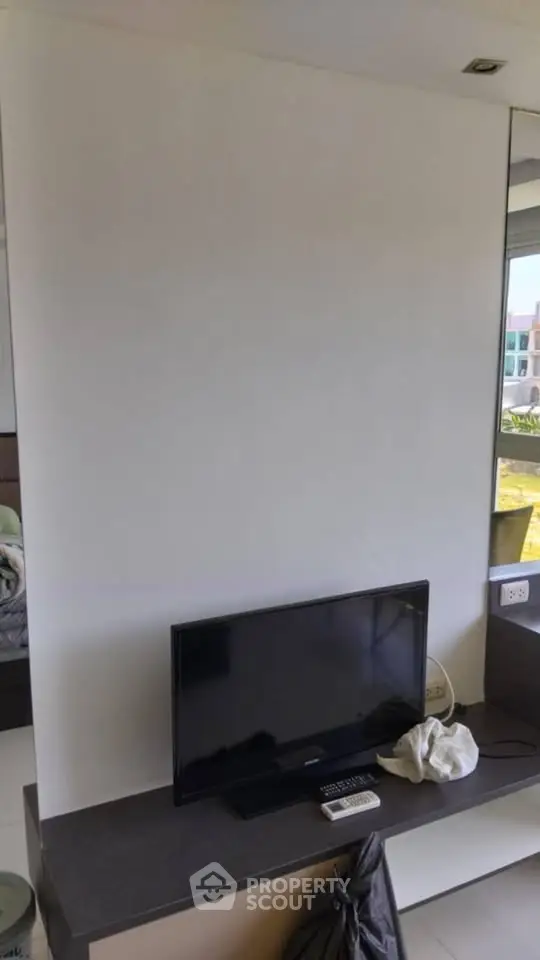 Modern living room with sleek TV setup and large window view