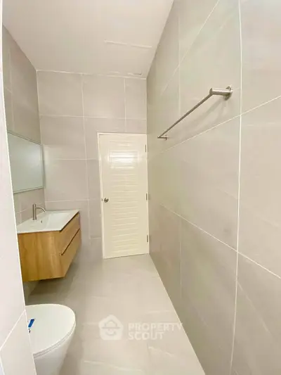 Modern minimalist bathroom with sleek fixtures and neutral tiles