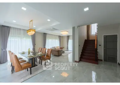 Luxurious open-plan living and dining area with elegant decor and natural light.