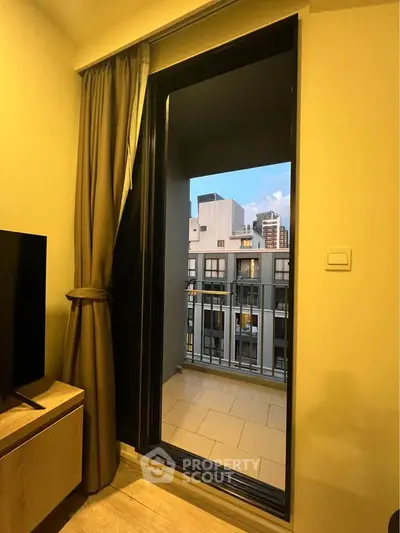 Modern apartment with balcony view of city skyline, perfect for urban living.