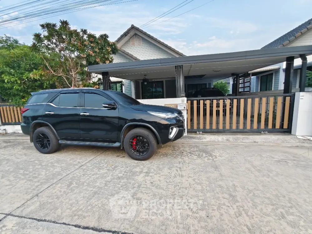 Charming suburban house with modern car parked in driveway, showcasing a stylish exterior and inviting entrance.