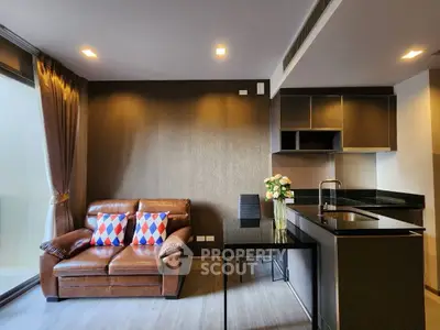 Modern living room with sleek kitchen and cozy leather sofa