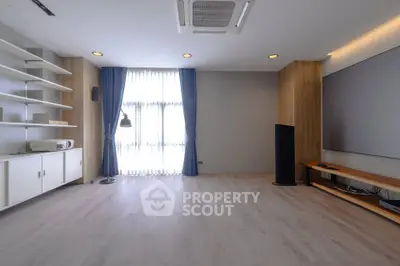 Spacious modern living room with large window and minimalist decor
