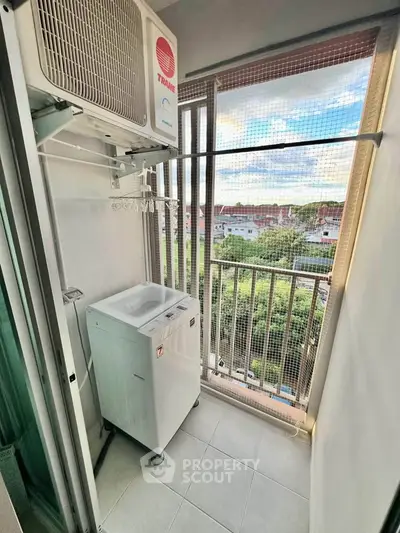Compact balcony with washing machine and scenic view in modern apartment