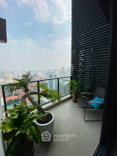 Stunning high-rise balcony with panoramic city views and lush greenery.