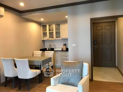 Cozy living room with dining area and modern kitchen in open layout apartment.
