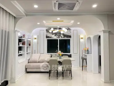 Elegant living room with modern decor, featuring a cozy sofa, dining table, and stylish lighting.