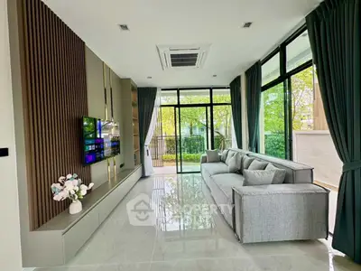 Spacious modern living room with large windows and stylish decor