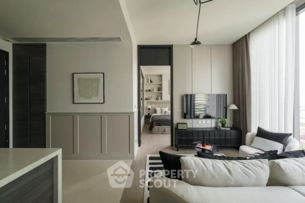 Modern living room with stylish decor and open view to bedroom