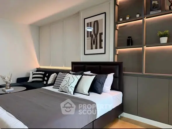 Modern bedroom with stylish decor and built-in shelving, perfect for contemporary living.