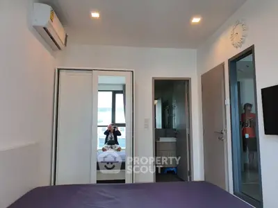 Modern bedroom with mirrored closet and air conditioning in a stylish apartment.