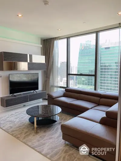 Modern living room with large windows and city view, featuring sleek furniture and contemporary design.