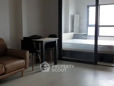 Modern apartment interior with cozy living area and bedroom view