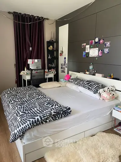 Cozy bedroom with modern decor and stylish bedding in a well-lit space.
