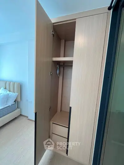 Modern bedroom with open wardrobe showcasing ample storage space and stylish design.