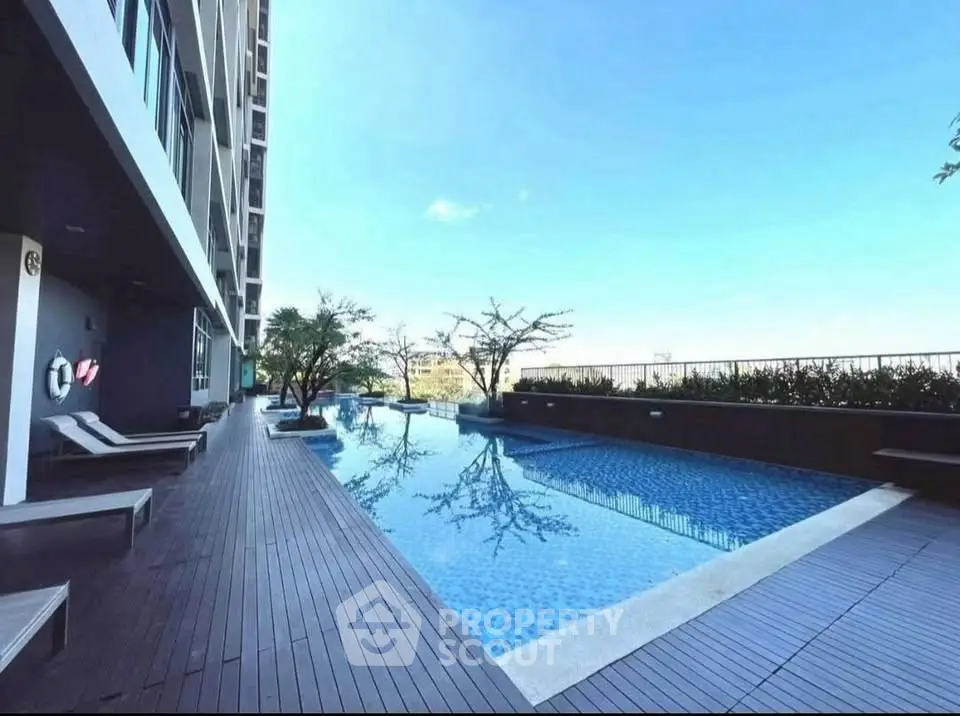 Luxurious modern apartment pool with stunning city view and elegant deck.