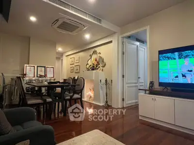 Elegant living room with dining area, featuring modern decor and ambient lighting.