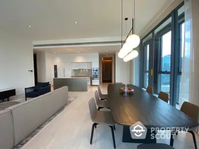 Luxurious open-plan living and dining area with modern kitchen and stunning city views.