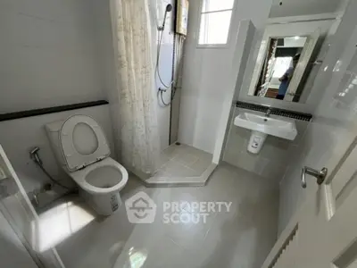 Modern bathroom with shower and toilet in bright, minimalist design