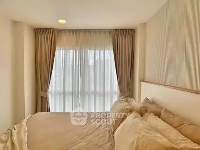 Cozy bedroom with large window and elegant curtains in modern apartment