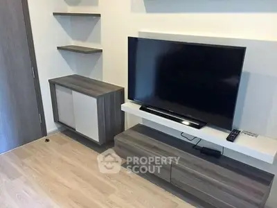 Modern living room with sleek TV stand and flat-screen TV, perfect for entertainment.