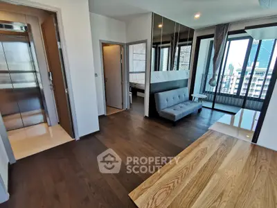 Modern apartment interior with wooden flooring and city view, featuring a cozy living area and elevator access.