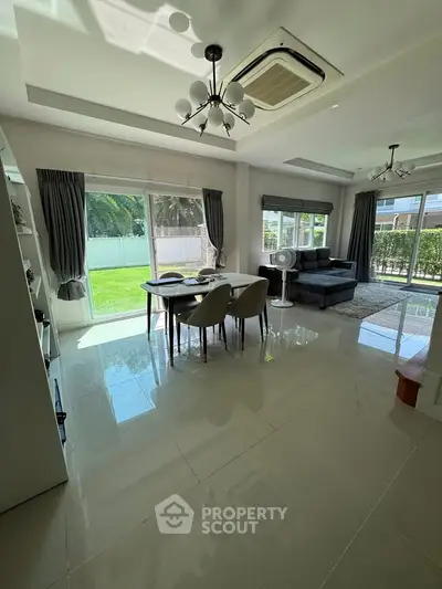 Spacious modern living room with garden view and elegant dining area