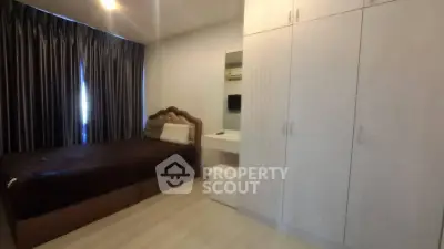 Cozy bedroom with modern furnishings and ample storage space