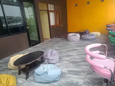 Spacious balcony with colorful bean bags and modern seating, perfect for relaxation and gatherings.