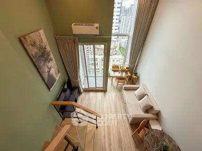 Stunning loft apartment with high ceilings and city view, featuring modern decor and open living space.