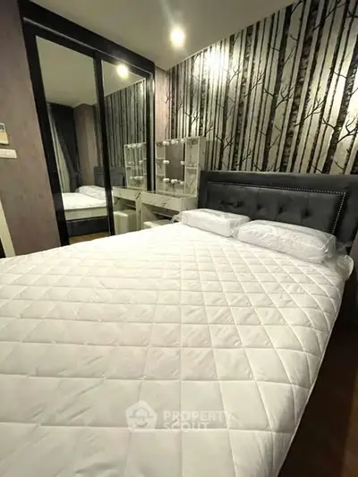 Modern bedroom with stylish wallpaper and mirrored wardrobe doors