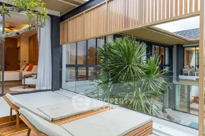 Luxurious modern home with spacious balcony and lush greenery, perfect for relaxation and entertaining.