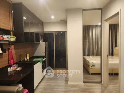 Modern apartment interior with sleek kitchen and cozy bedroom