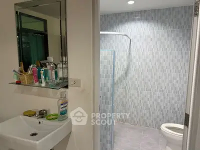 Modern bathroom with glass shower and sleek fixtures