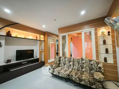 Stylish living room with modern decor and built-in shelving, perfect for relaxation and entertainment.