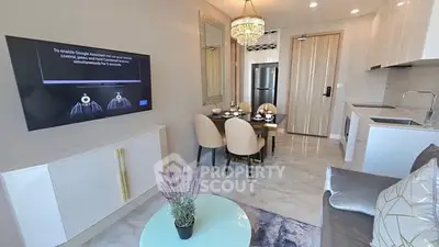 Modern living room with open kitchen, elegant dining area, and smart TV setup.