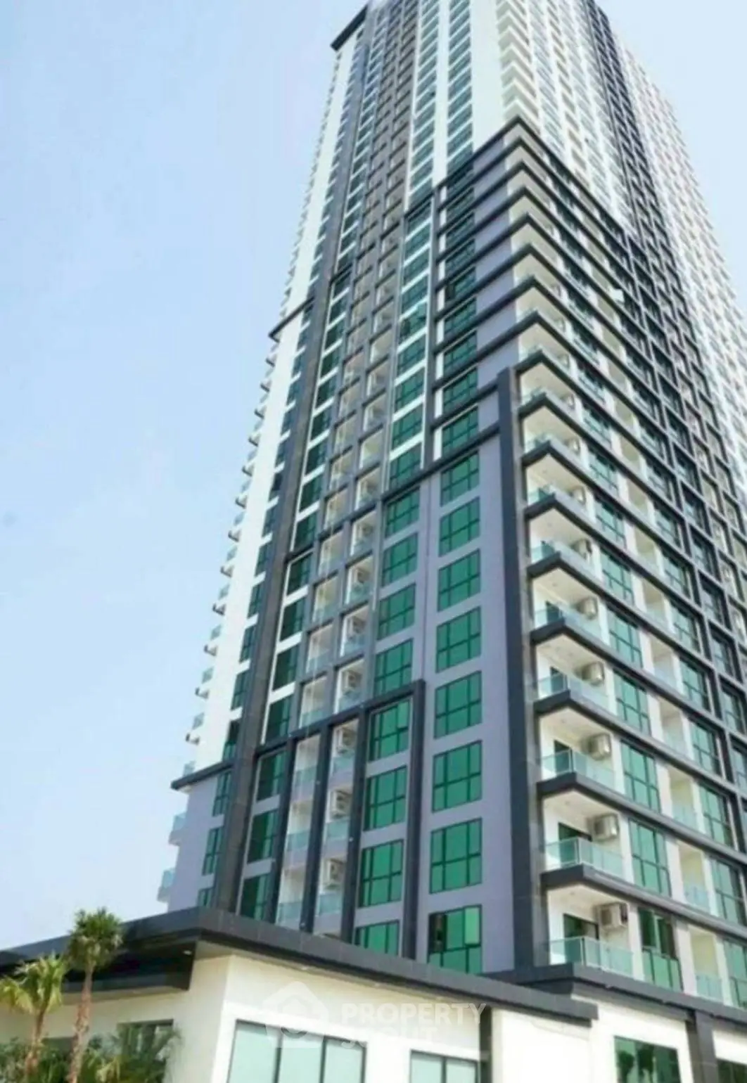 Stunning high-rise building with modern architecture and expansive windows in urban setting.