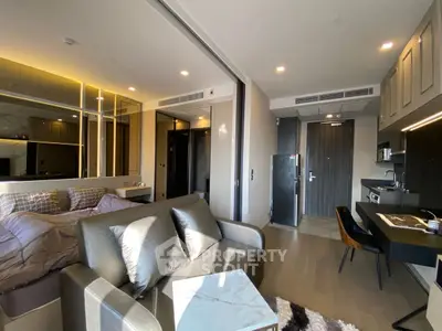 Modern studio apartment with sleek design and open layout, featuring a cozy living area and stylish kitchen.
