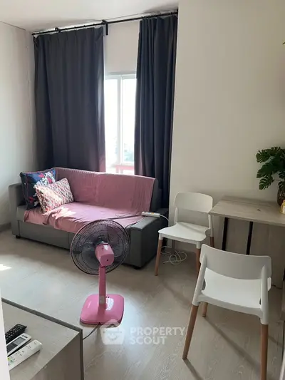 Cozy living room with modern furniture and natural light, perfect for relaxation.