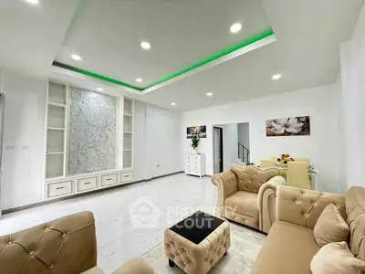Spacious modern living room with elegant furniture and stylish ceiling lighting.