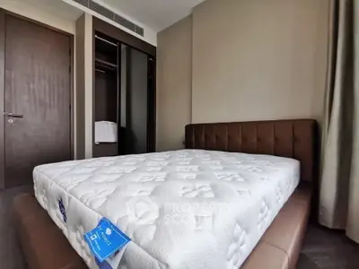Modern bedroom with plush mattress and sleek wardrobe in a stylish apartment.