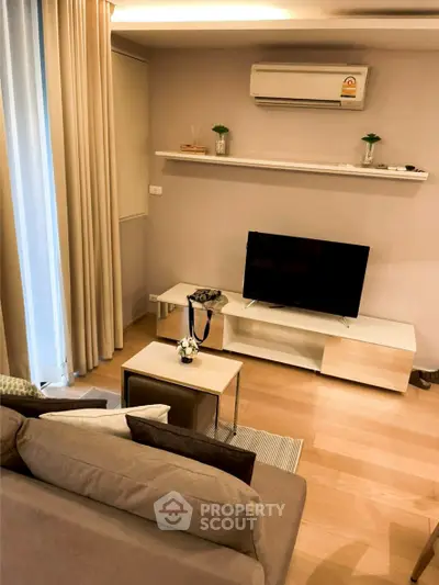Modern living room with sleek furniture and air conditioning, perfect for relaxation.
