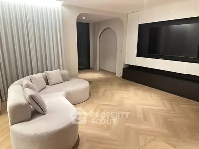 Elegant modern living room with stylish curved sofa and large TV unit