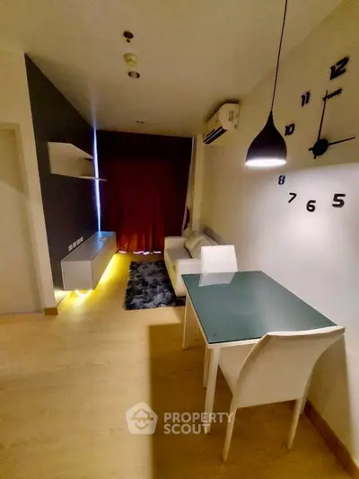 Modern living room with stylish decor and dining area in a cozy apartment.