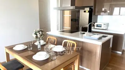 Modern kitchen with dining table and sleek cabinetry in open layout