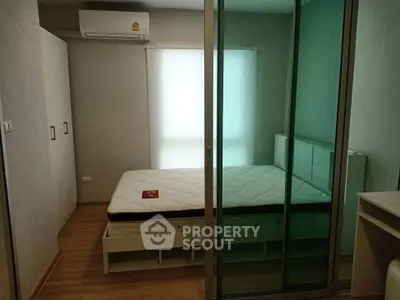 Modern bedroom with glass sliding doors and air conditioning unit